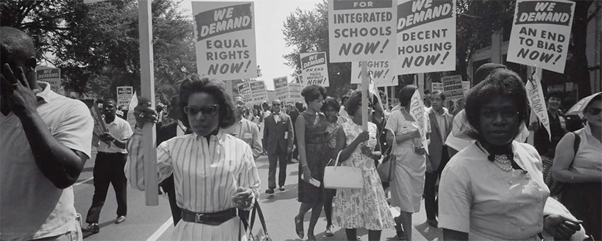 civil rights protesters holding signs that say we demand equal rights, integrated schools and decent housing now