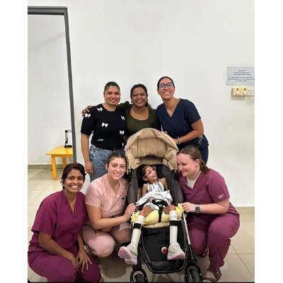 Students posing with a client at the clinic
