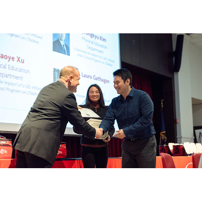 Dominick Fantacone, director of research and sponsored programs, left, presented a faculty research award.