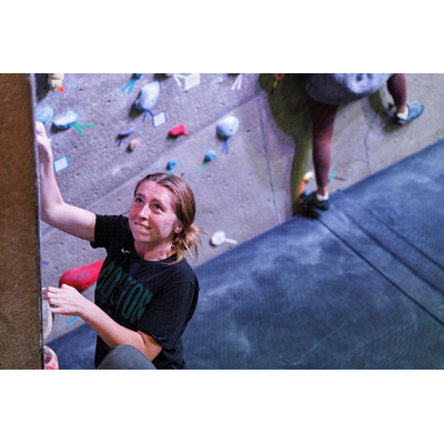 A student relaxes at the Student Life Center climbing wall