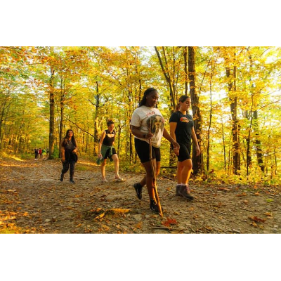 Students hiking through the woods in autumn