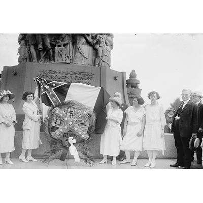 Families and dignitaries attend a statue dedication