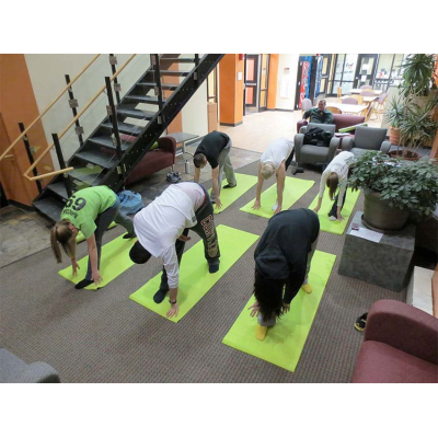 A group of students doing yoga together in Alger Hall
