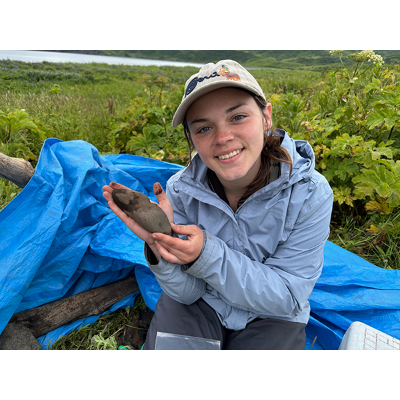 Sierra Polivka-Curri displays an Alaskan summer archaeological finding.