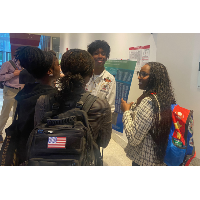 Bradley Blake, center in white, explains his research to NOBCChE Conference attendees