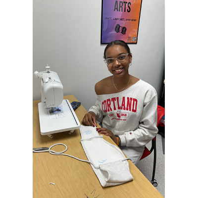 Student sews retrofitted sweatshirt