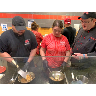 Two cooks-in-training learn technique