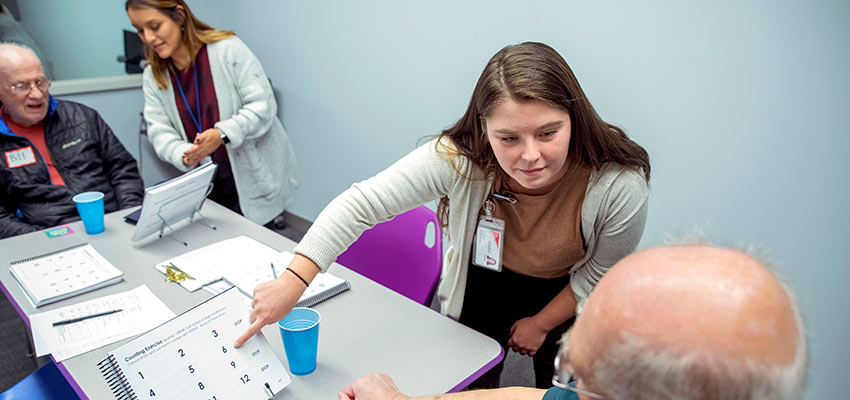 SUNY Cortland grad students working with a Parkinson's Disease group speech therapy.