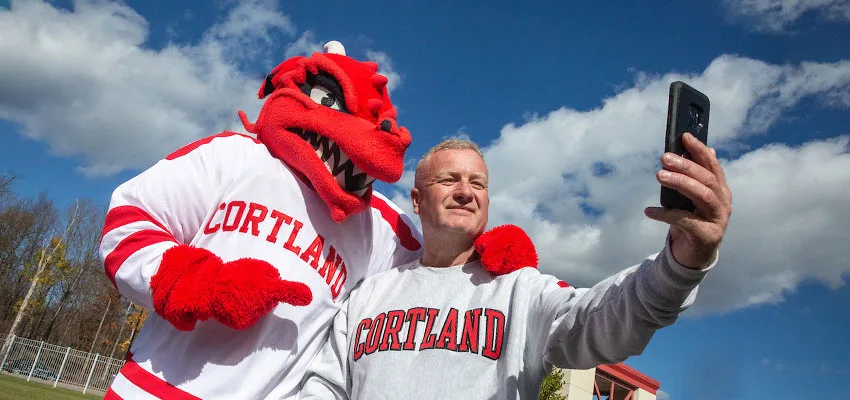 Dad in a Cortland sweatshirt takes a selfie with Blaze