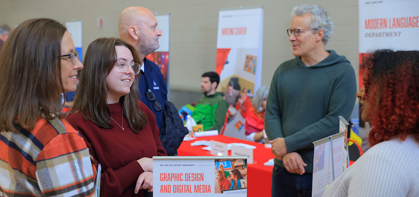 A prospective student talks to current graphic design student at the Fall open house