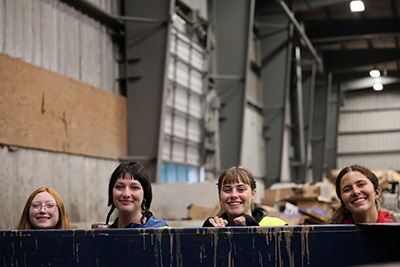 Green Reps looking at a dumpster