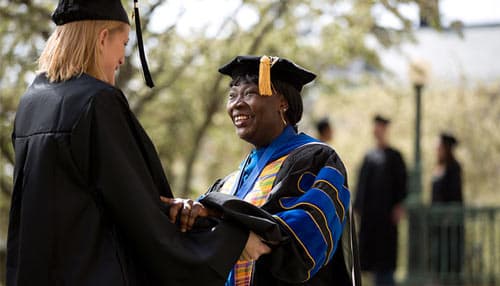 Professor congratulating a student at graduation