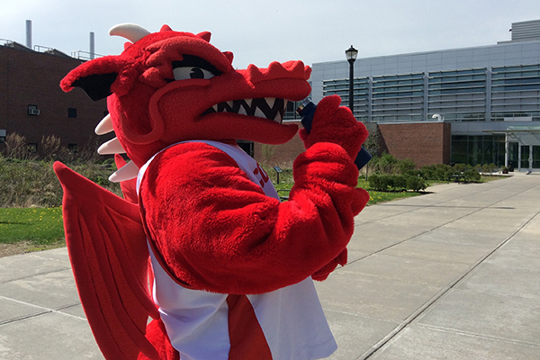 Blaze drinking from water bottle outside Bowers Hall