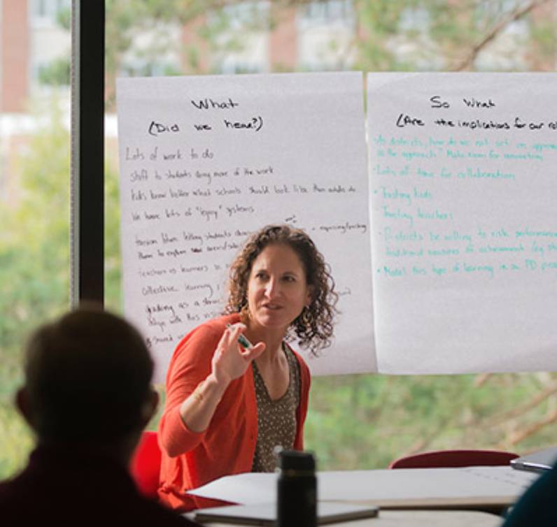Teachers taking notes at a workshop