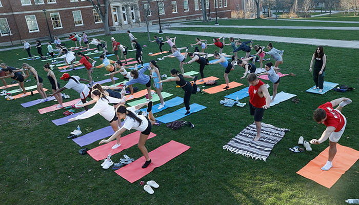 Students doing yoga on the Moffett Center lawn
