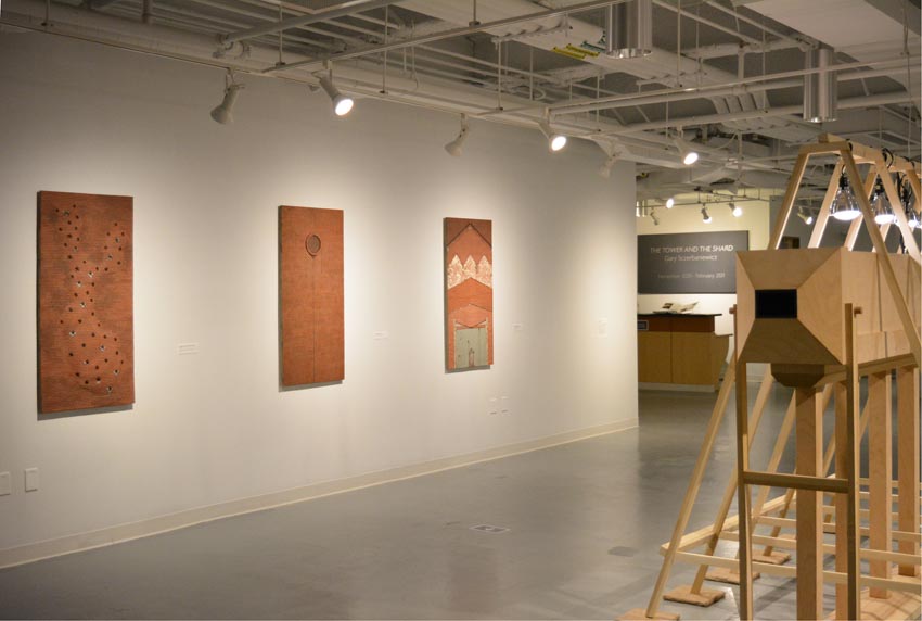 View into the central gallery at Dowd Gallery featuring sculptural objects produced by Buffalo-based sculptor Gary Sczerbaniewicz.   