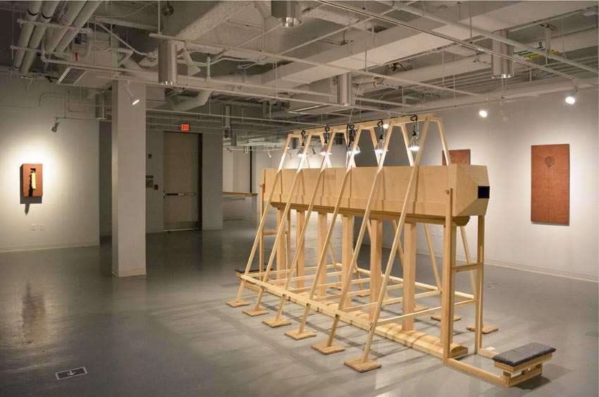 View into the central gallery at Dowd Gallery featuring sculptural objects produced by Buffalo-based sculptor Gary Sczerbaniewicz.