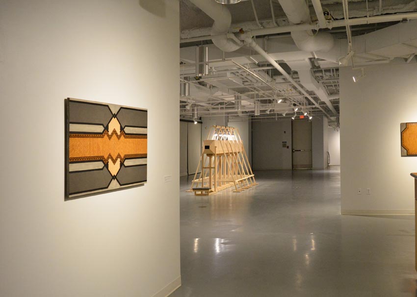 View into the central gallery at Dowd Gallery featuring sculptural objects produced by Buffalo-based sculptor Gary Sczerbaniewicz.   