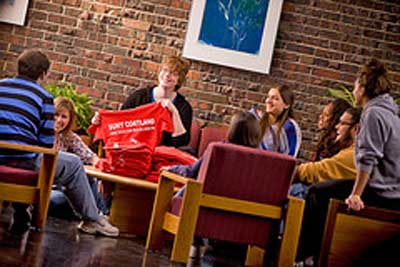 A professor demonstrating to a small group of Health Education bachelor's students