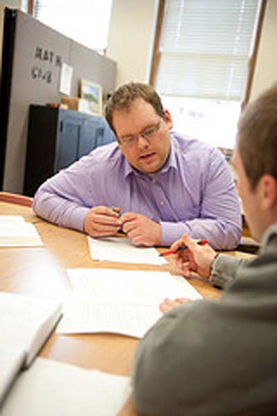 Student teacher gaining hands-on experience mentoring high school math student