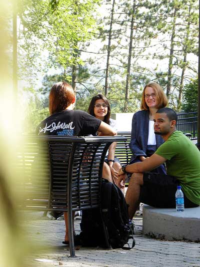 Philosophy majors having a small group discussion with a professor outside of the classroom