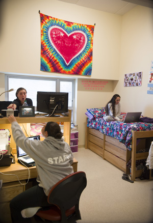 three students relax in their suite