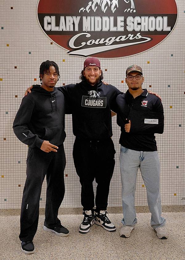 Two C.U.R.E. students, Ikenna Okoye and Joe Martinez, posed for a photo with a C.U.R.E. mentor Andr&eacute;s Miranda in the middle