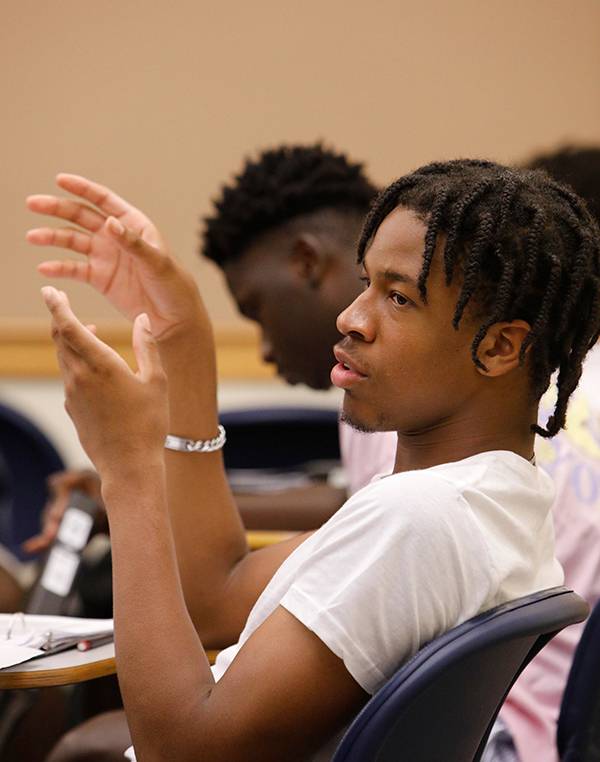 Ikenna Okoye speaks with his hands during class